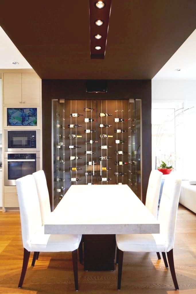 Luxury Custom Home Wine Cellar with Glass Floating Wine Racks Built in a Dining Room