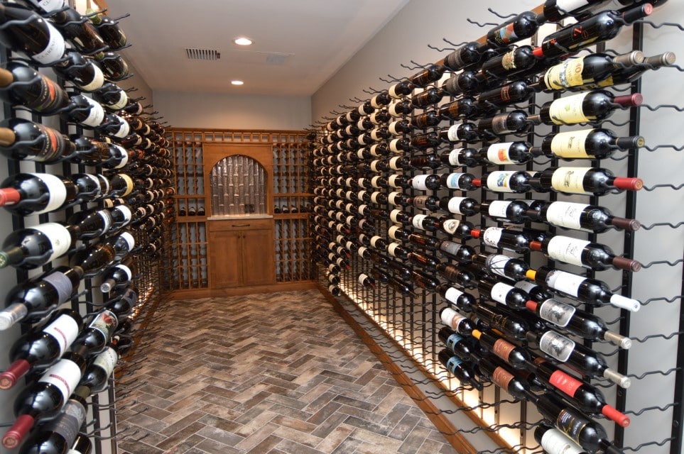 wine cellar with a mix of modern metal wine racks and traditional wooden shelves and door