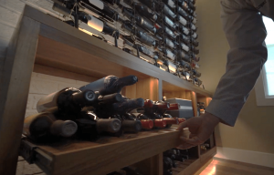 8 - Custom Cable Wine Displays and a Sliding Cabinet Beneath It