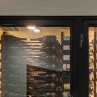 (3) A black metal finish enhances the contrast of this glass wine closet.