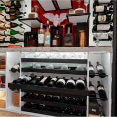 (12) Custom pull-out drawers—quiet, smooth, and beautifully fitted—hold everything from everyday table wines to stemware, creating a unified system where storage never interrupts the aesthetic.